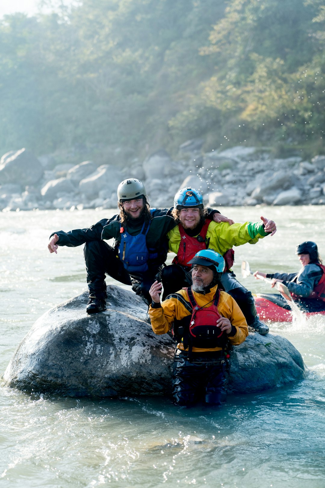 a-group-of-people-riding-on-top-of-a-rock-in-a-river-gh00eyufe4g