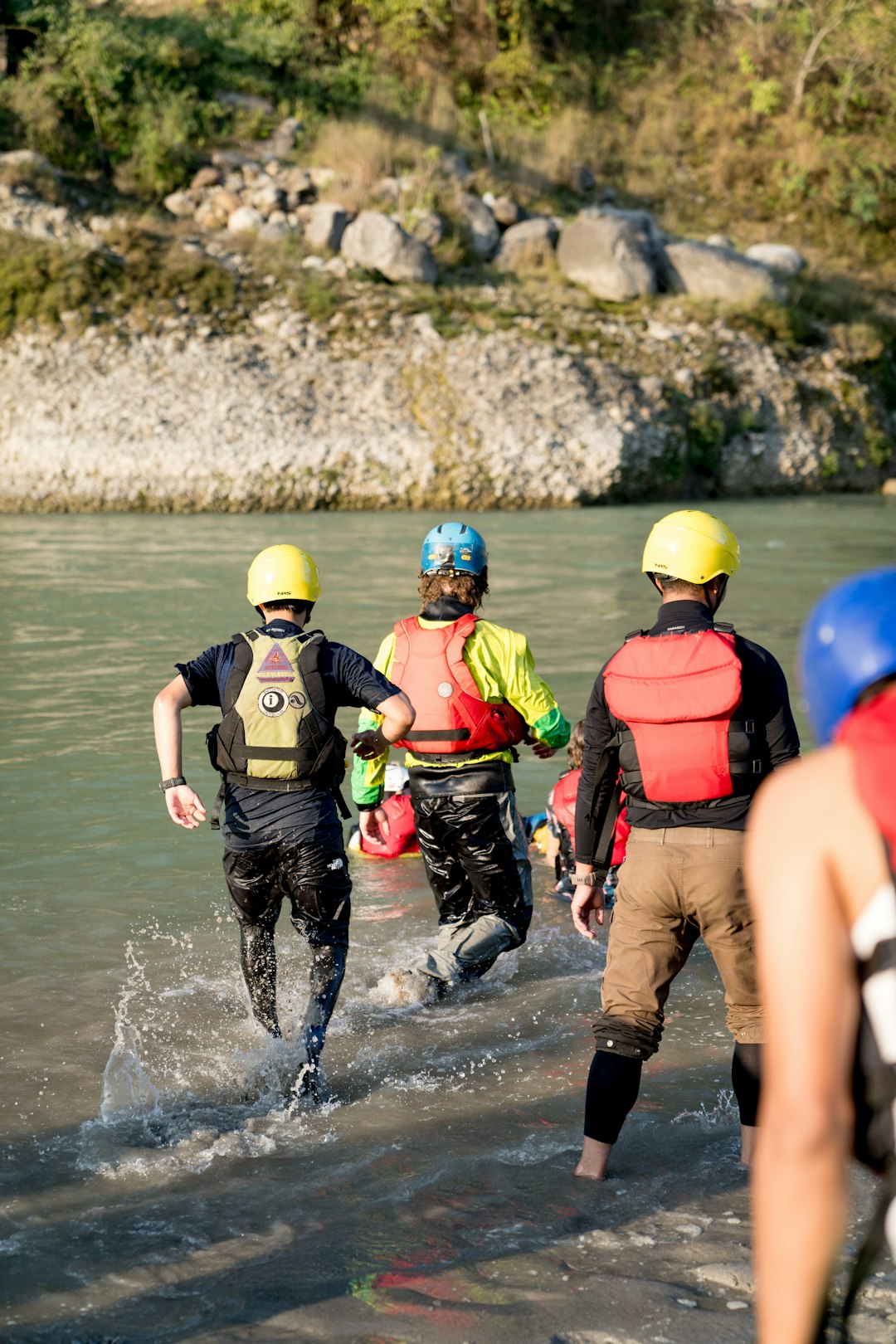 a-group-of-people-walking-across-a-river-s-liju21dxu