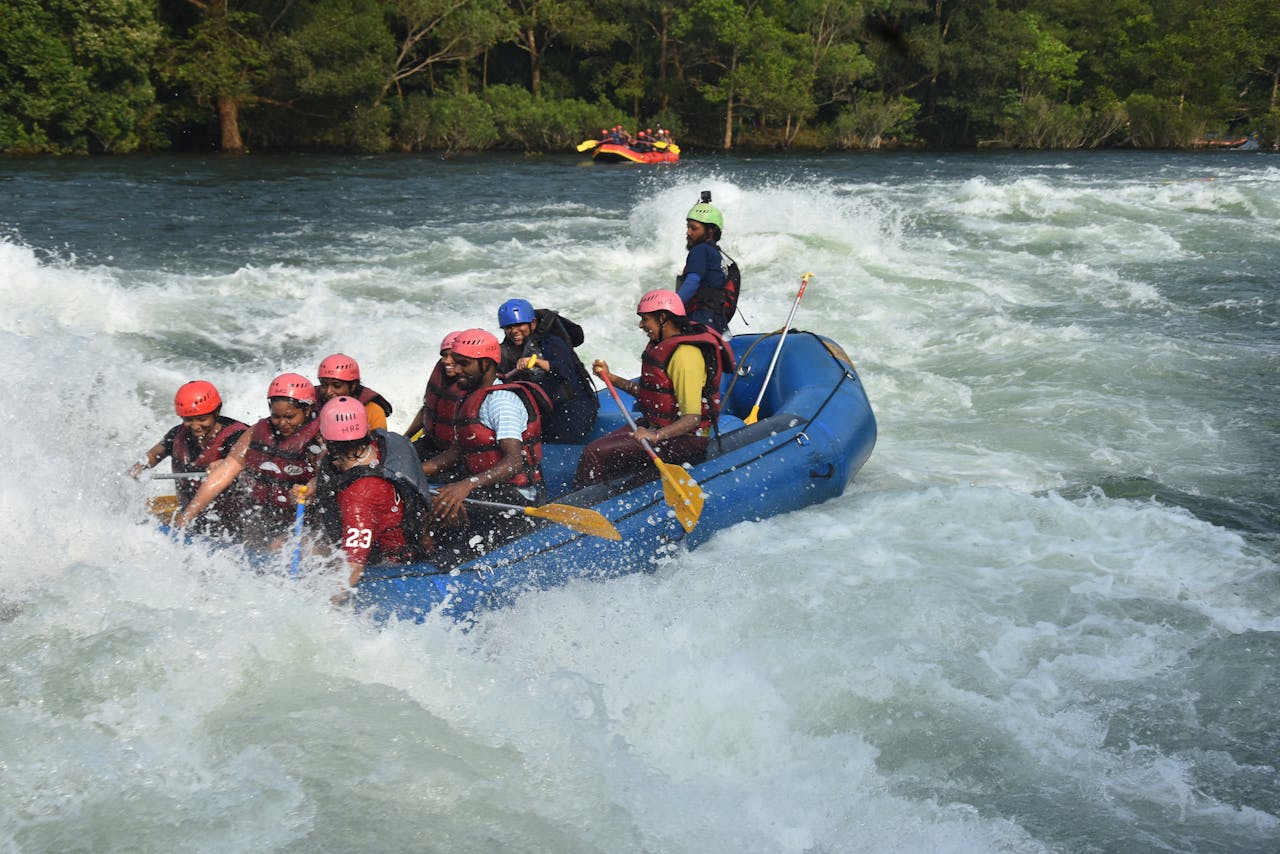 Group of people enjoying an intense river rafting experience on turbulent rapids.
